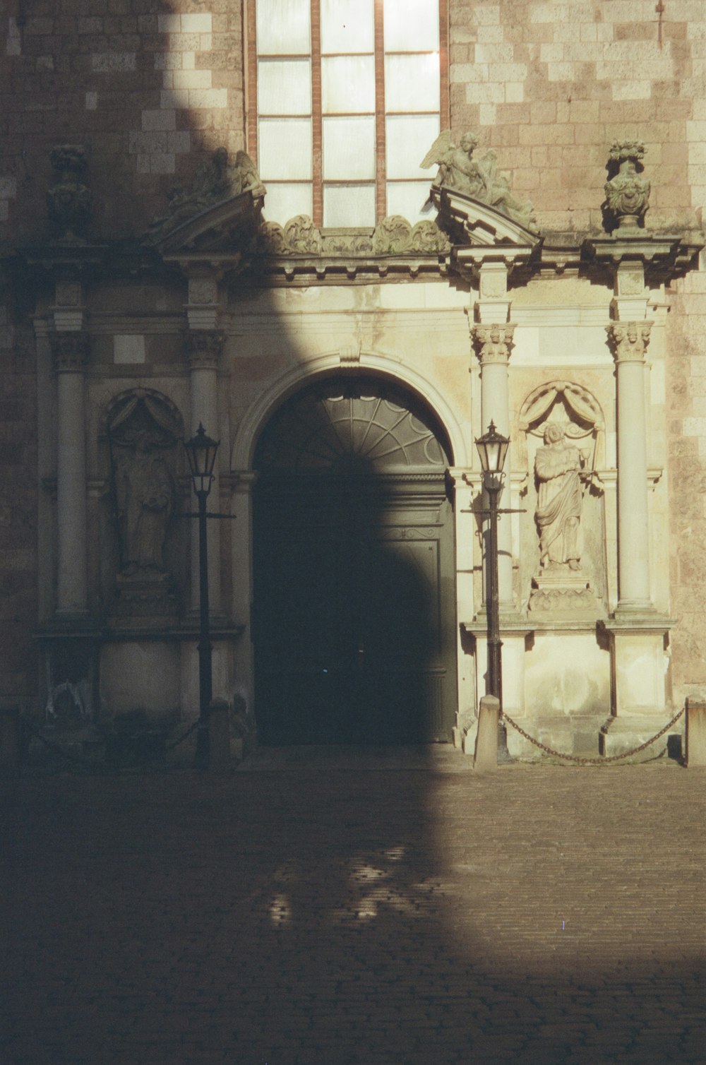 a large building with a doorway and a statue on the outside of it