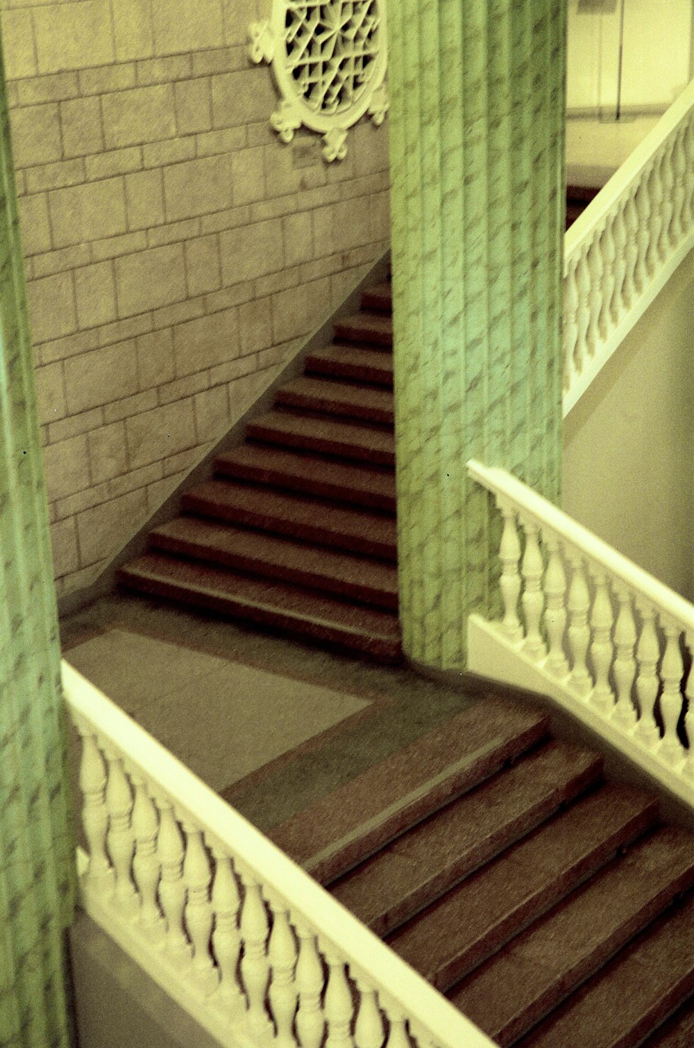 a staircase with a clock on the side of it