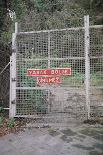 A professional sliding iron gate with razor wire on top, securing a residential site in Turkey.