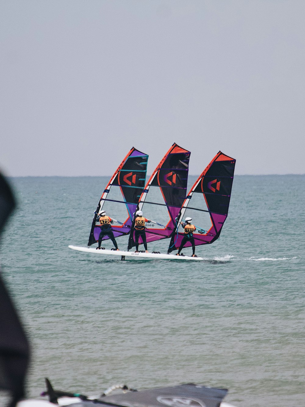 a group of people wind surfing in the ocean