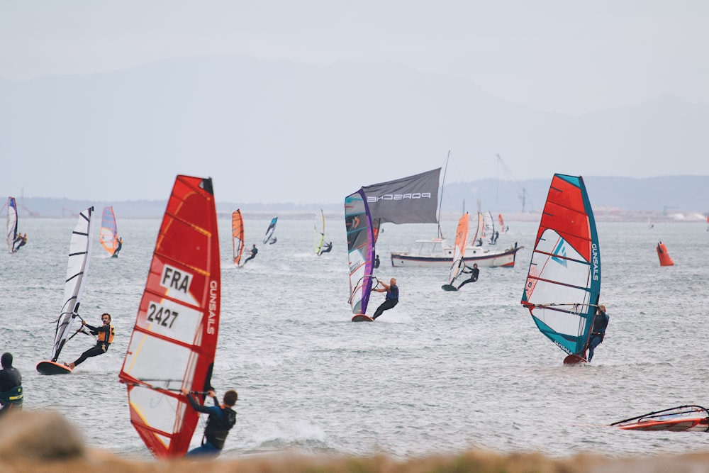 a group of people wind surfing in the ocean