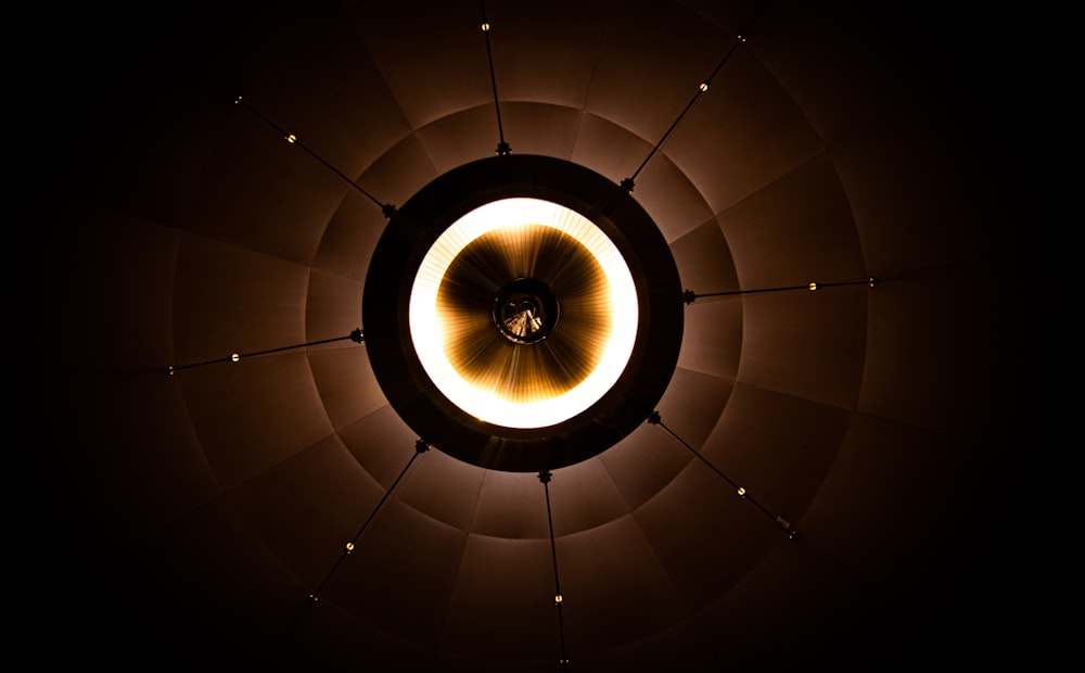 a circular light fixture in a dark room