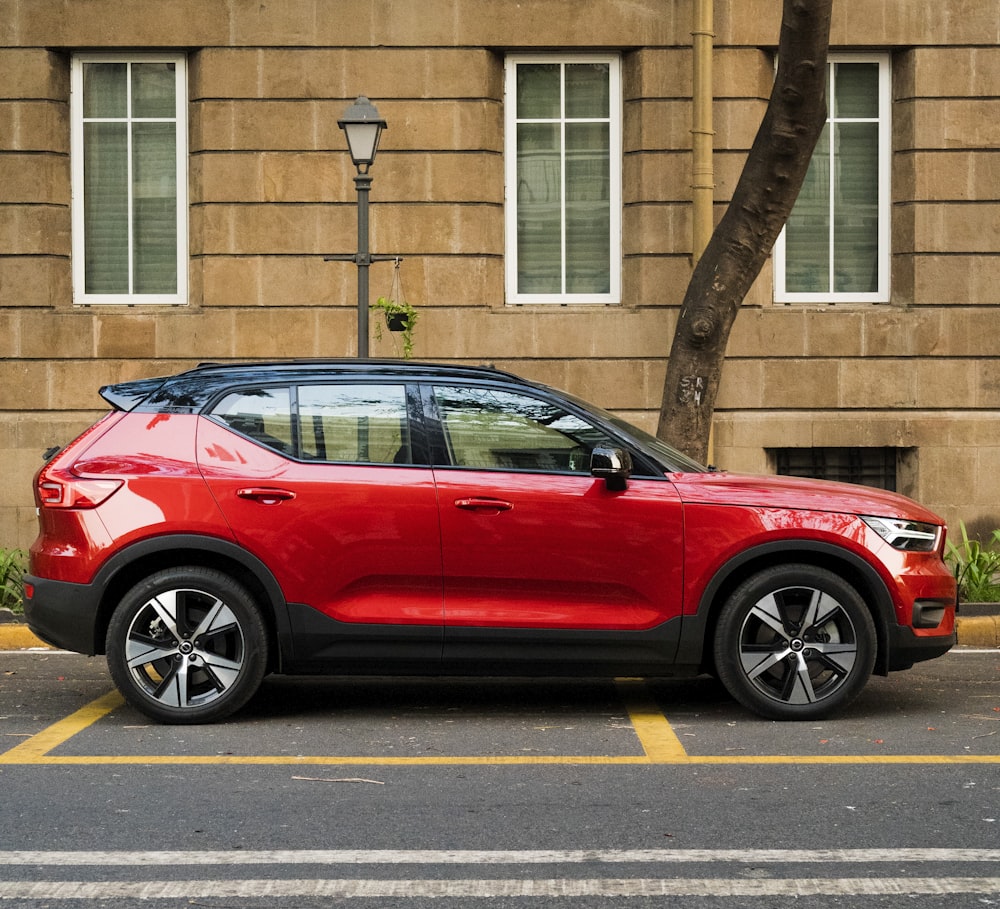 a red car parked in front of a building