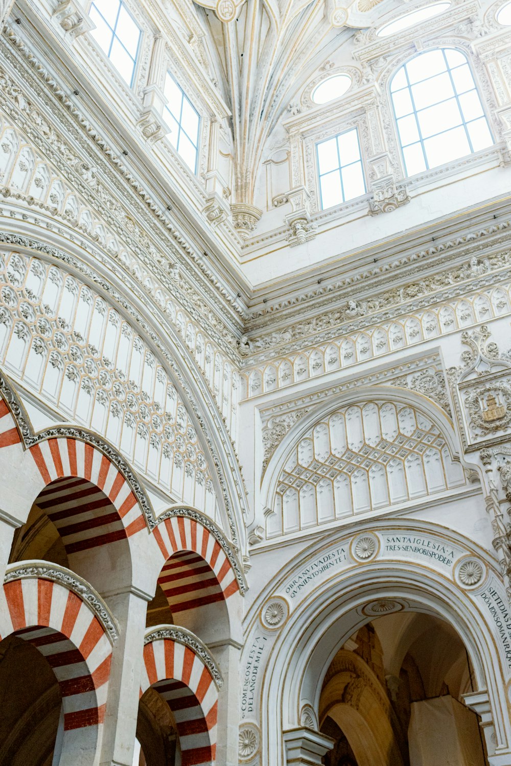 the ceiling of a building with arches and arches