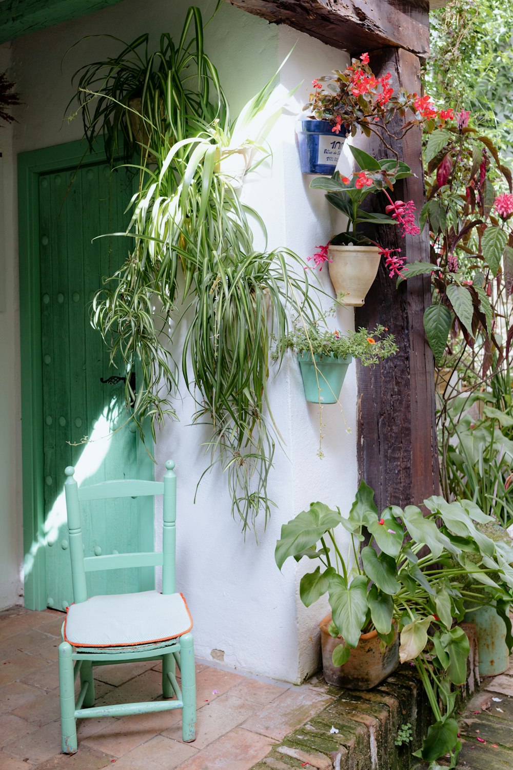 a green chair sitting in front of a green door