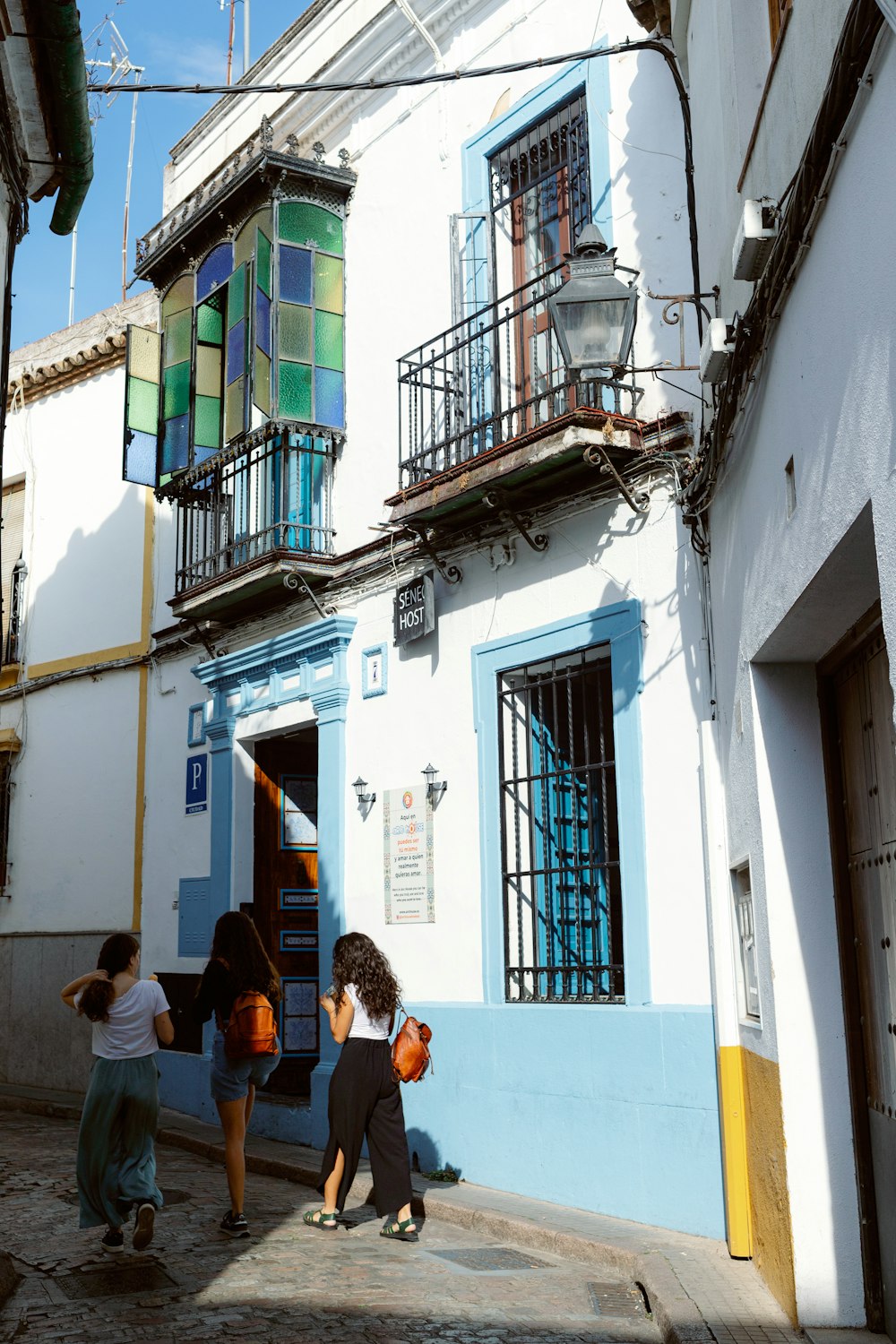 a group of people walking down a street next to a building