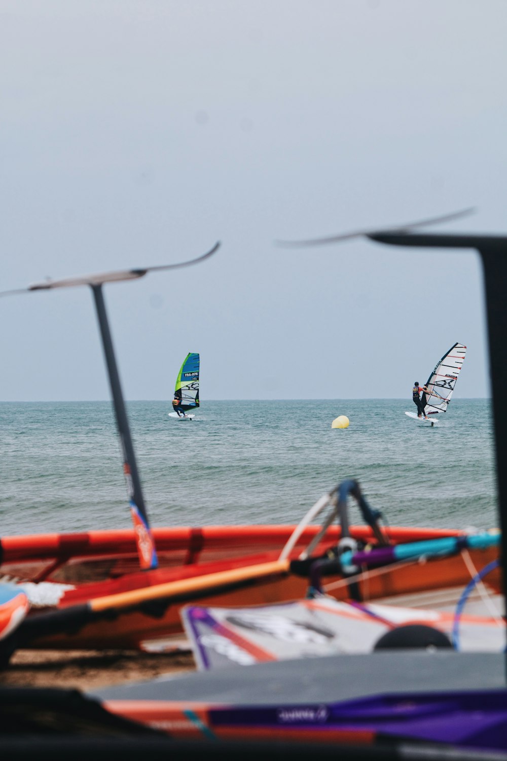 a group of people windsurfing in the ocean