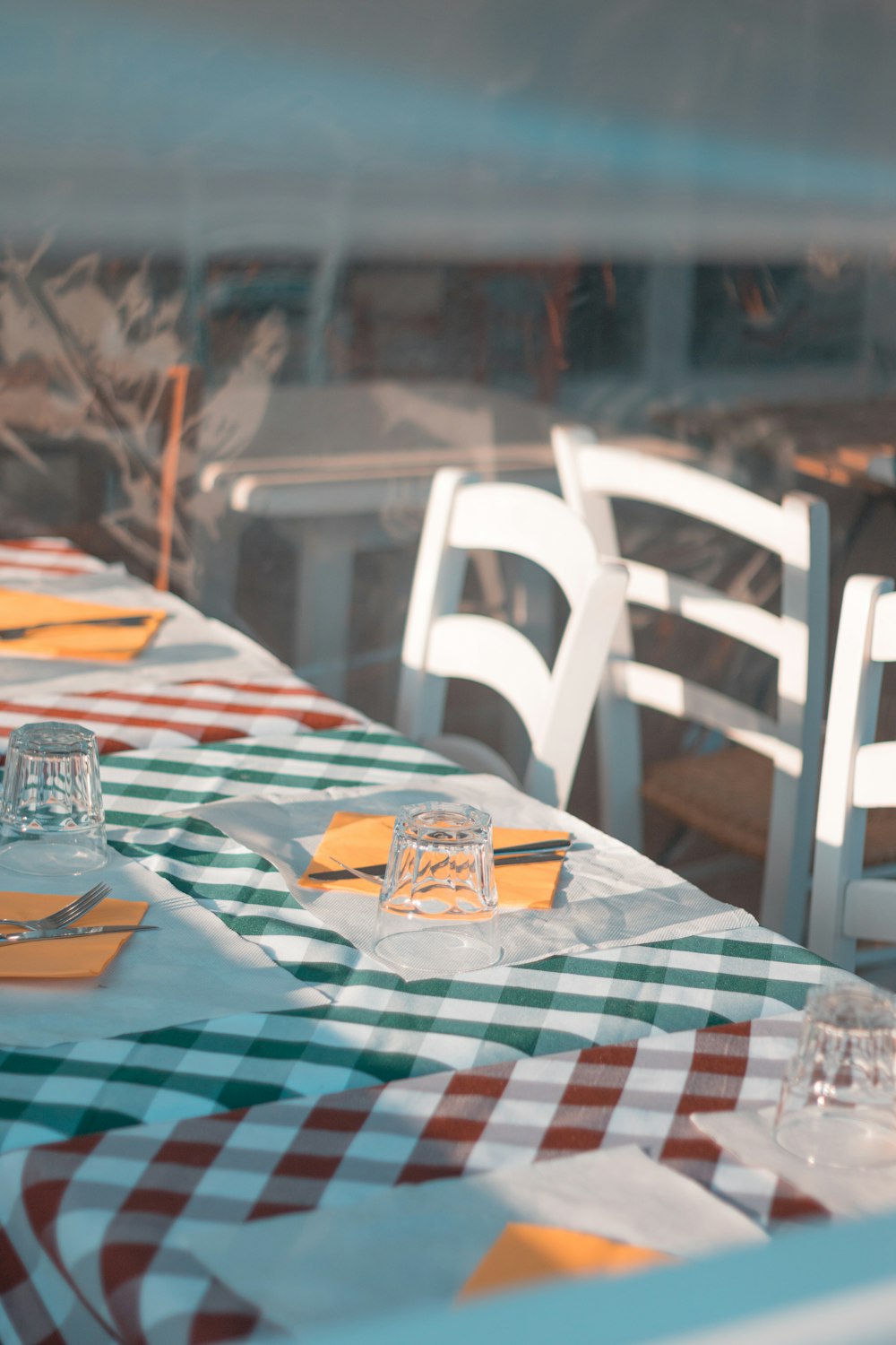 a table with a checkered table cloth and place settings