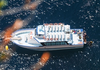 a white boat floating on top of a body of water