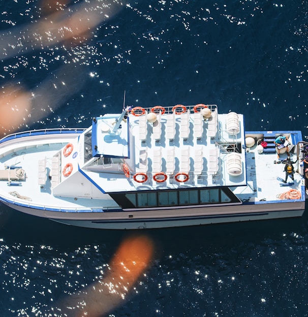 a white boat floating on top of a body of water