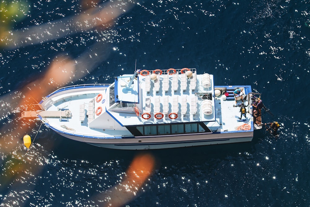 a white boat floating on top of a body of water