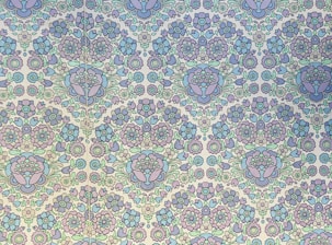 Close-up of a hand-painted Indian folk art floral motif in soft pastel tones.