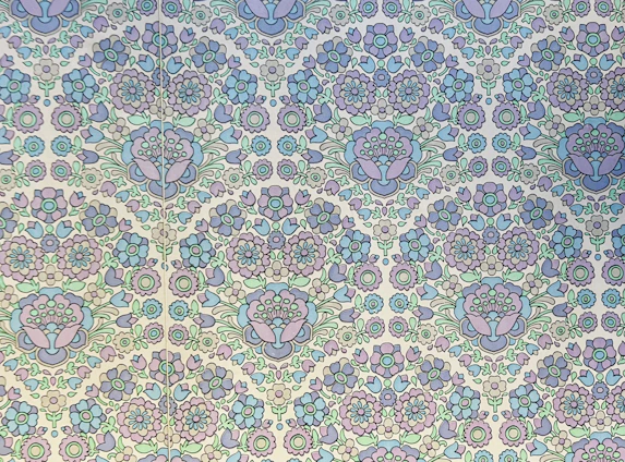 A serene montage of pastel white and pink floral prints layered with delicate Rajasthani-inspired patterns.