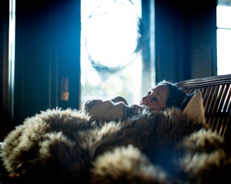 A client and reader sharing a quiet moment of reflection during a tarot session surrounded by soft fabrics.