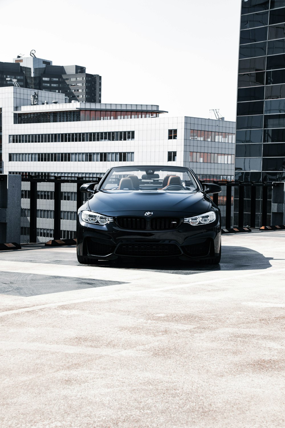 a black sports car parked in a parking lot