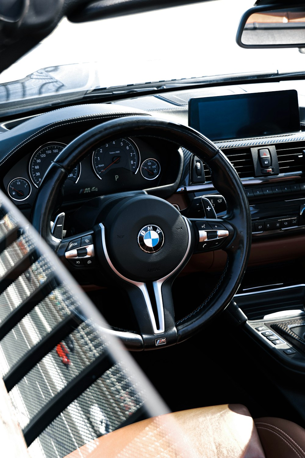 the interior of a car with a steering wheel and dashboard