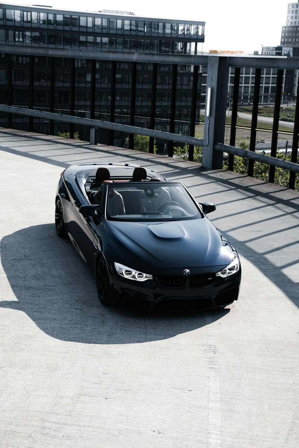 a black sports car parked in front of a building