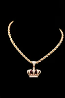 a gold necklace with a crown on it