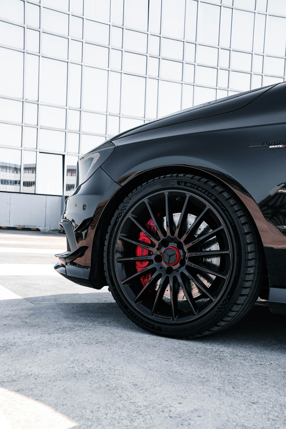 a black car parked in front of a building