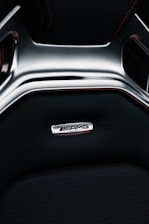 Interior view of the luxurious red Mercedes C-Class AMG with leather seats and ambient lighting.