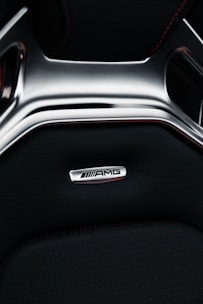 Interior view of the luxurious red Mercedes C-Class AMG with leather seats and ambient lighting.