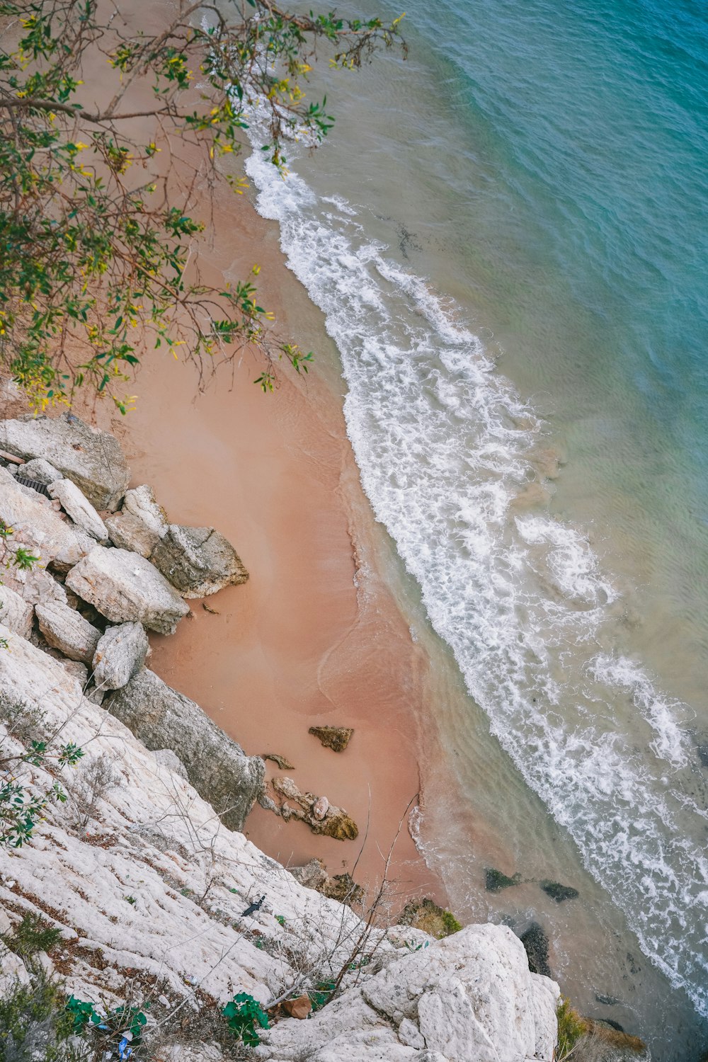 a view of the beach from above a cliff