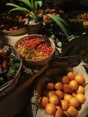 a table topped with baskets filled with lots of fruit