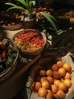 a table topped with baskets filled with lots of fruit