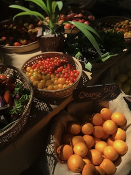 a table topped with baskets filled with lots of fruit