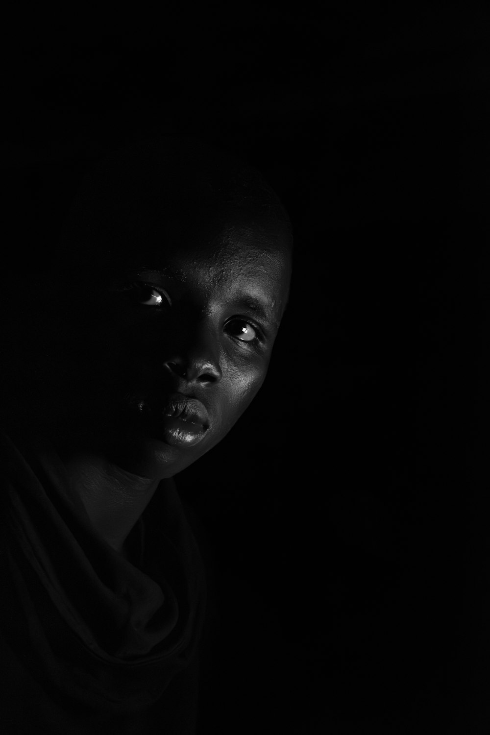 a black and white photo of a person in the dark