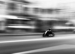 a man riding a motorcycle down a street