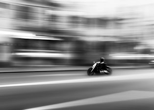 a man riding a motorcycle down a street