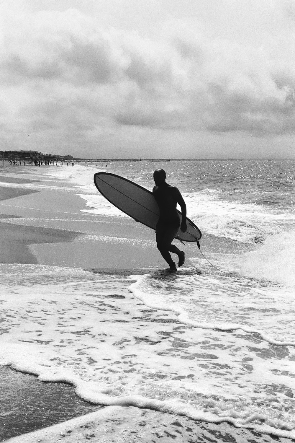 a man carrying a surfboard into the ocean