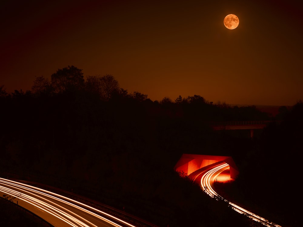 a long exposure photo of a highway at night