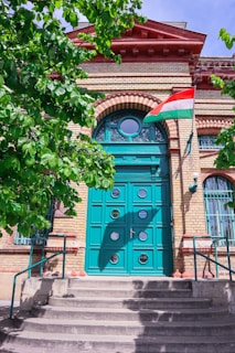 a large blue door with a flag on top of it