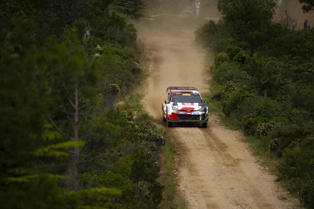 a rally car driving down a dirt road