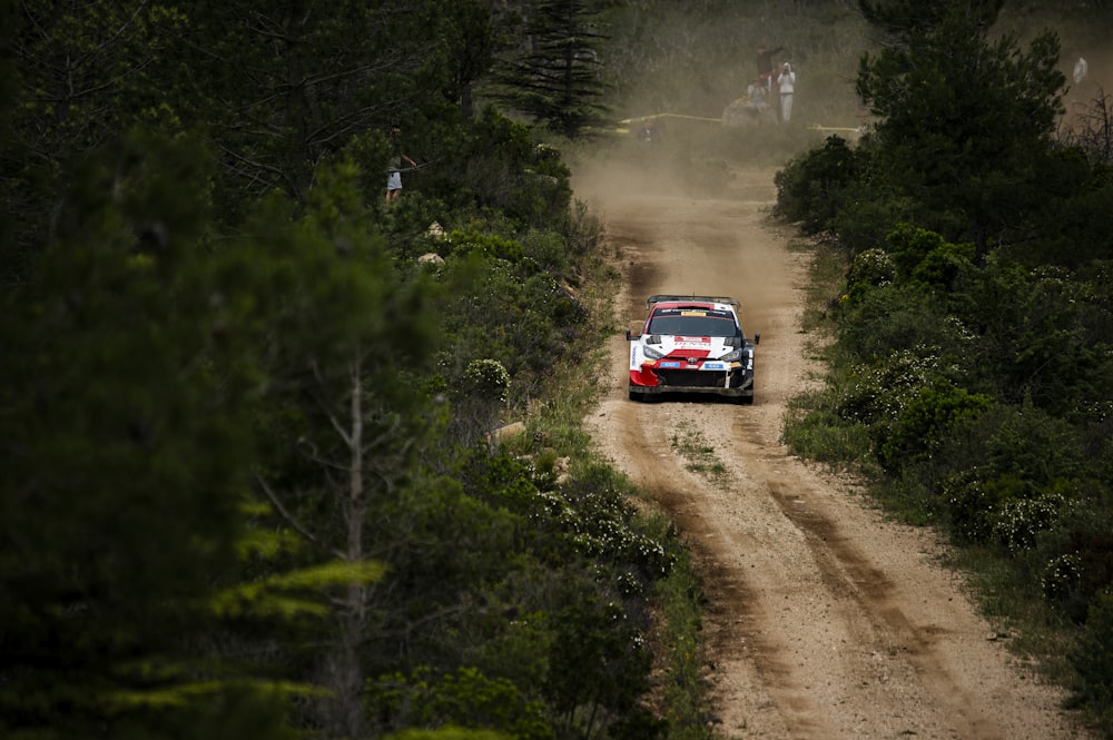 a rally car driving down a dirt road