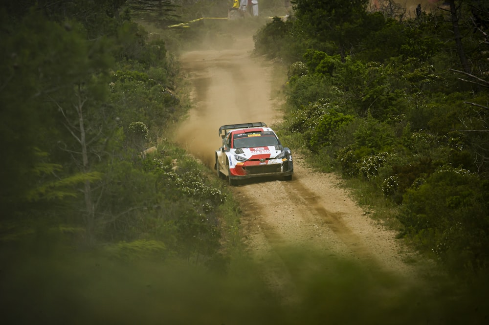 a rally car driving down a dirt road