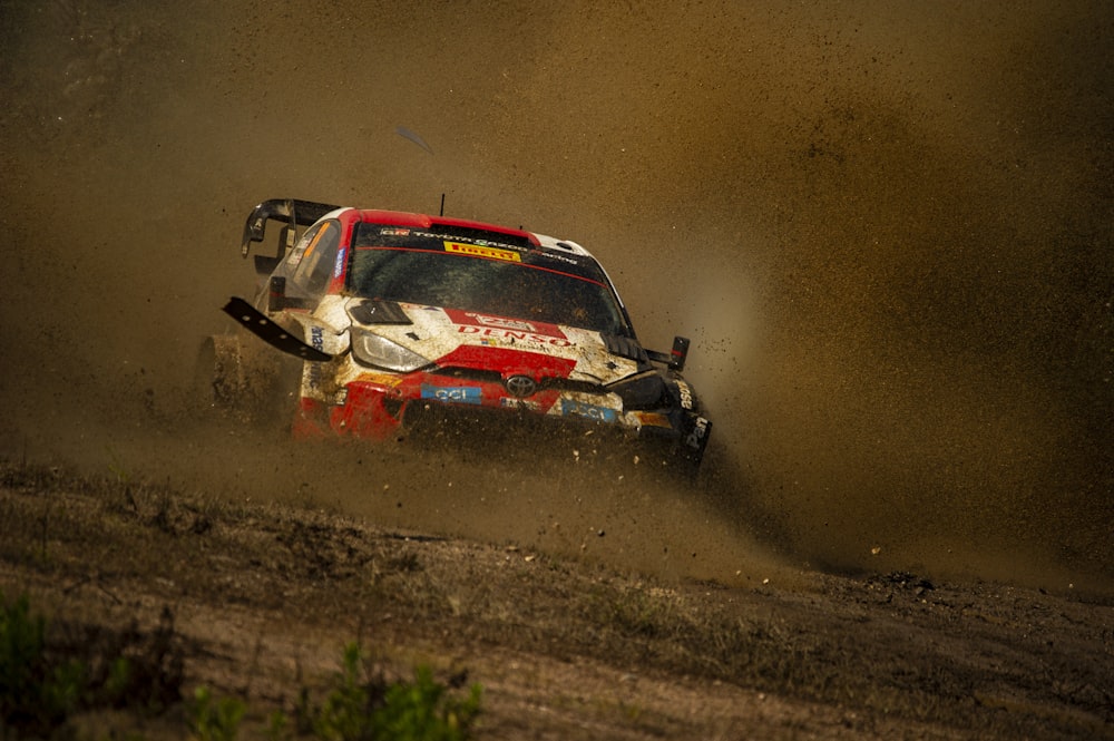 a rally car making a turn on a dirt track