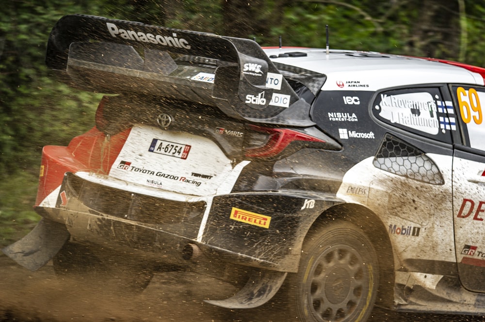 a rally car driving on a dirt road