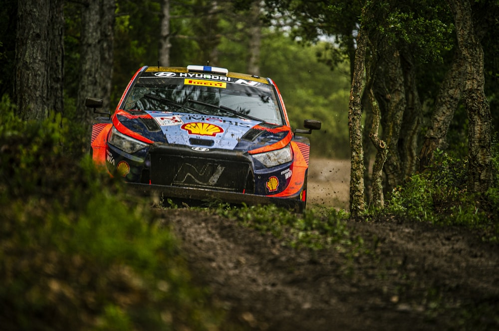 a rally car driving down a dirt road