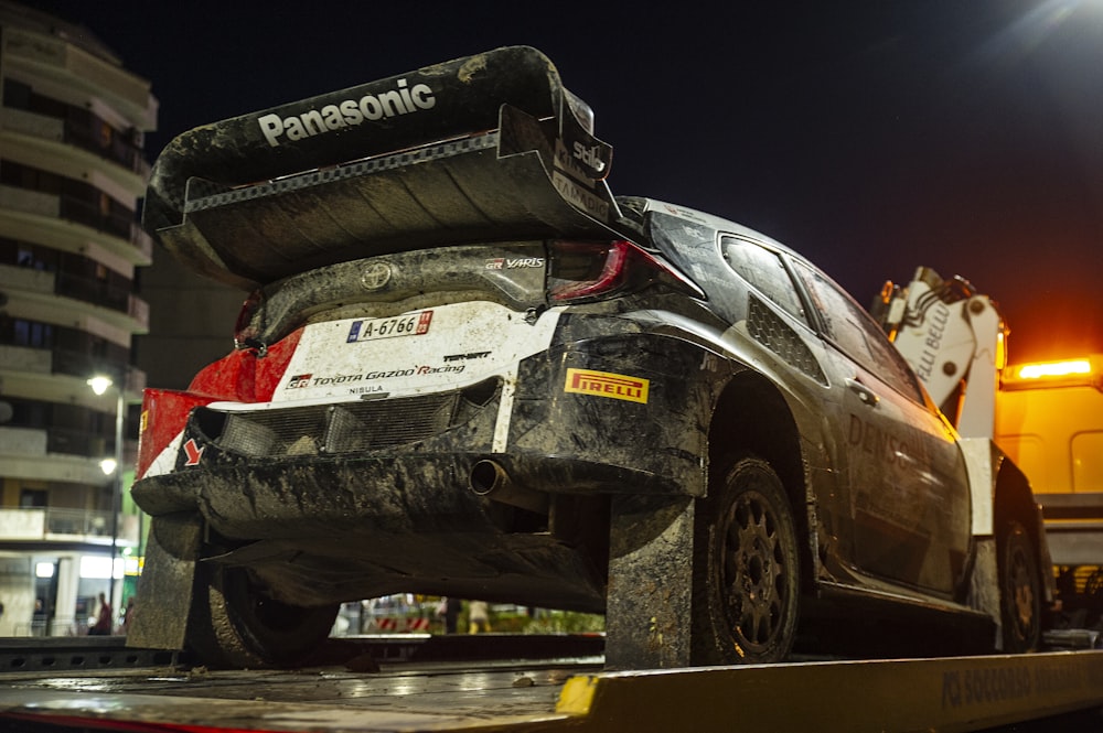 a car that is sitting on the back of a truck