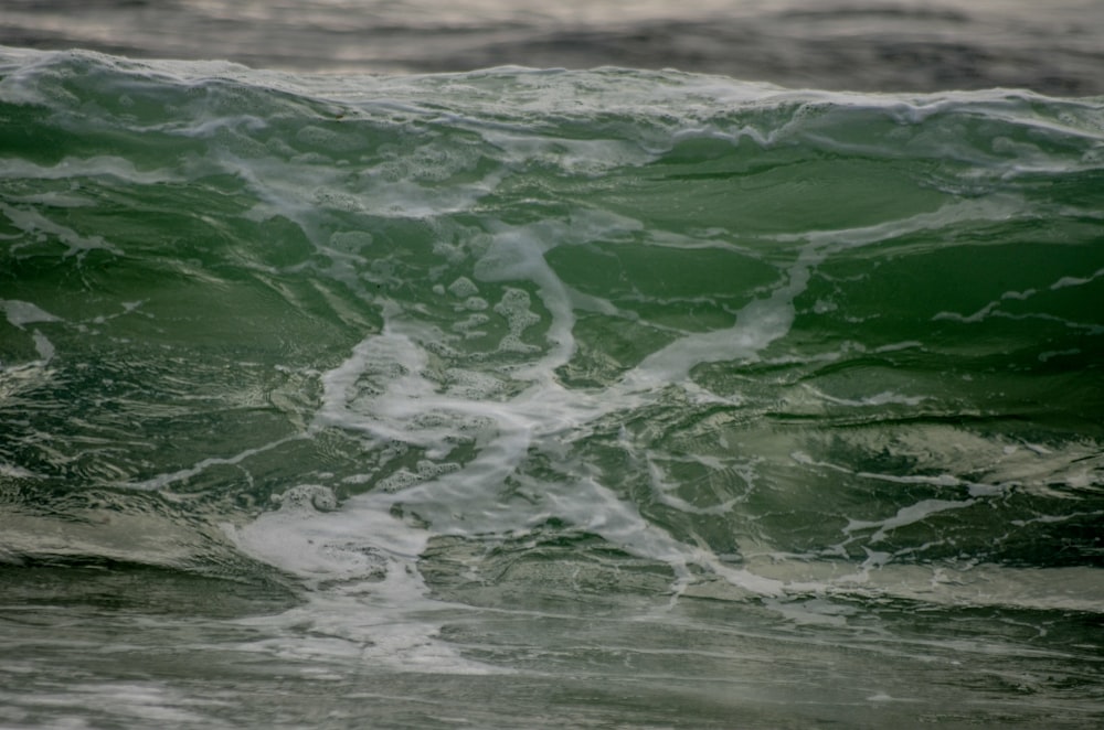 a man riding a wave on top of a surfboard