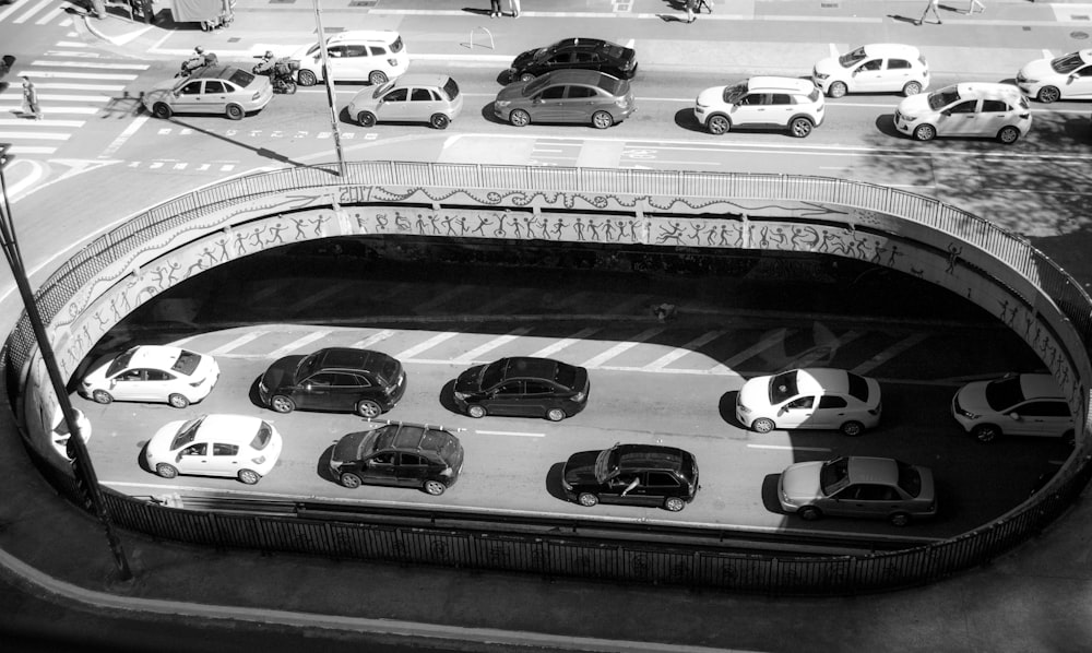 a black and white photo of a street filled with cars