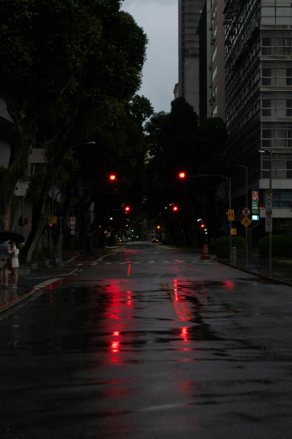a city street at night with red traffic lights