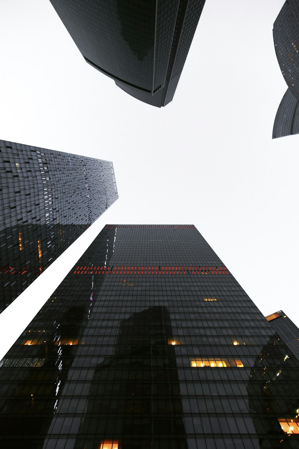 looking up at skyscrapers in a city at night