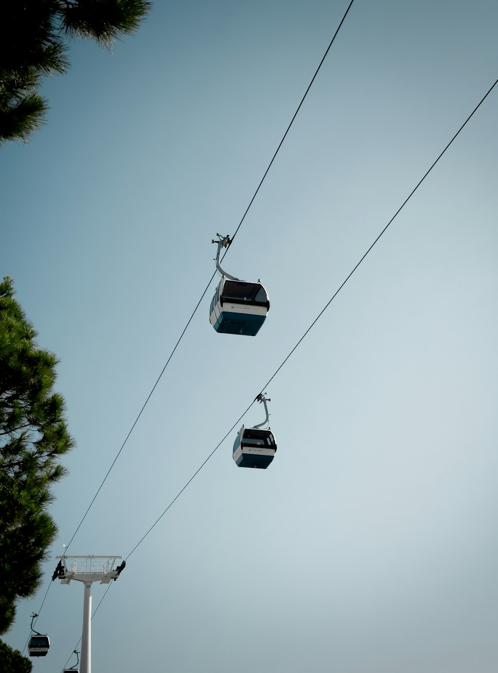 a couple of gondolas hanging from a wire