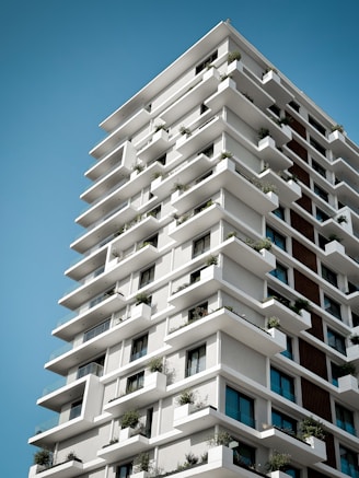 a tall white building with lots of windows