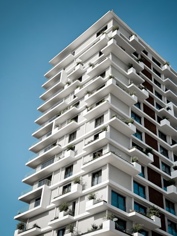 a tall white building with lots of windows