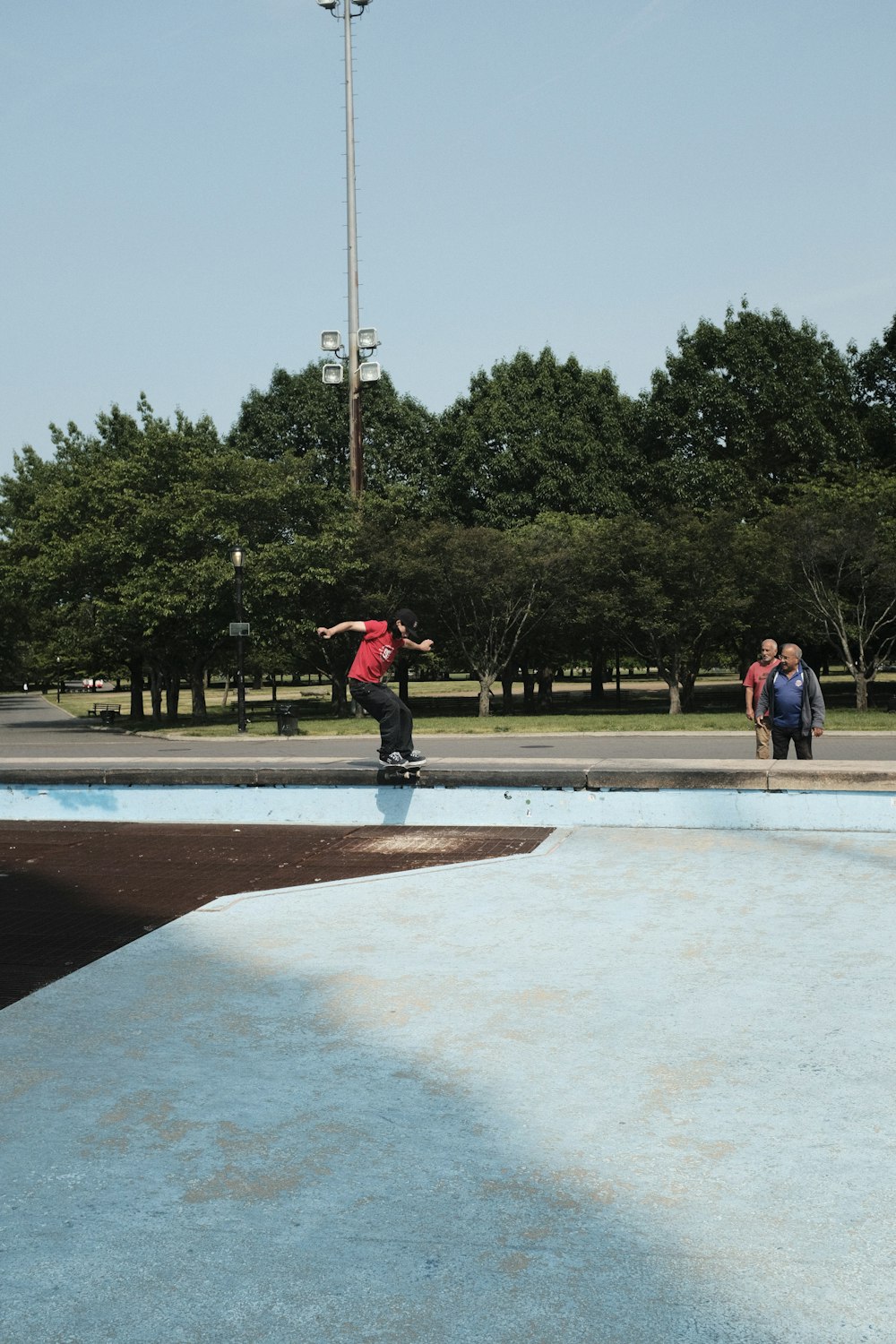 a man riding a skateboard on top of a blue ramp